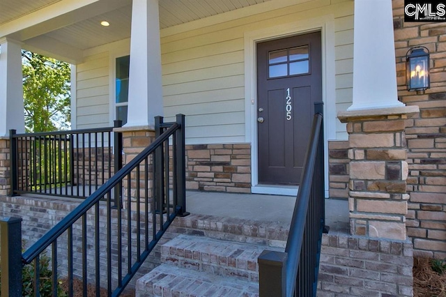 view of exterior entry with covered porch