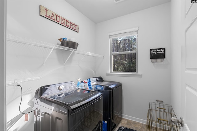 clothes washing area featuring independent washer and dryer