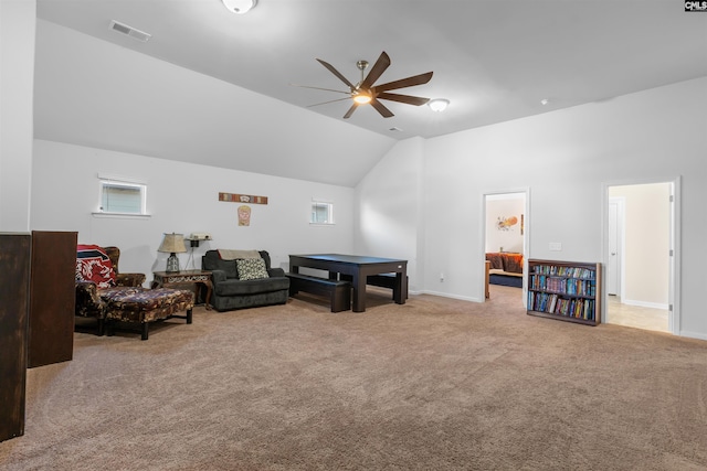 recreation room with ceiling fan, light colored carpet, and vaulted ceiling