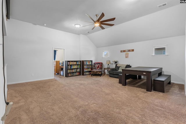 interior space with ceiling fan, carpet floors, and vaulted ceiling