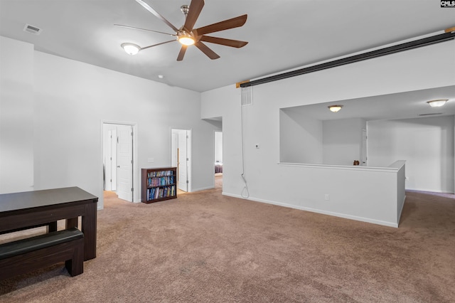 carpeted empty room featuring ceiling fan