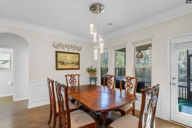 dining space featuring dark hardwood / wood-style floors and ornamental molding