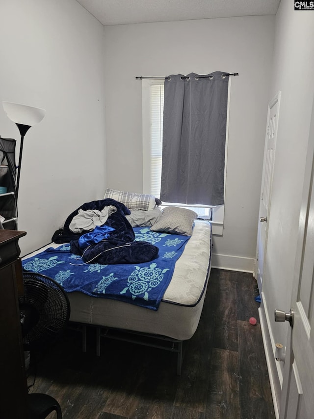 bedroom featuring dark wood-type flooring