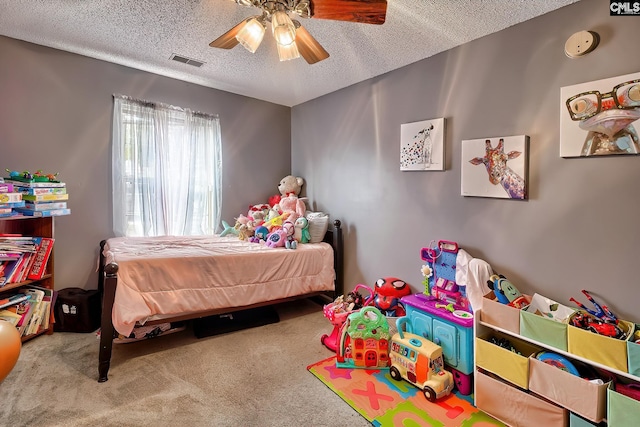 bedroom with carpet flooring, ceiling fan, and a textured ceiling