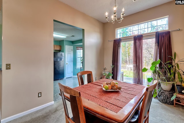 carpeted dining room with a textured ceiling and a notable chandelier