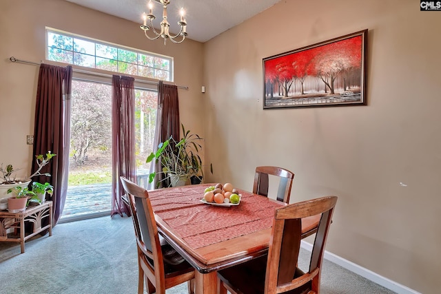 dining space featuring carpet floors and an inviting chandelier