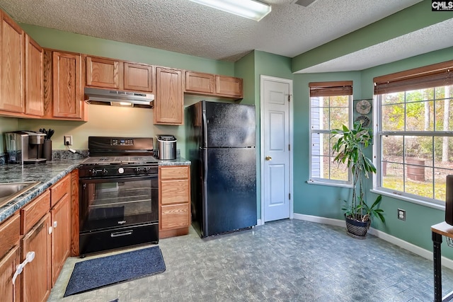 kitchen with black appliances and a textured ceiling