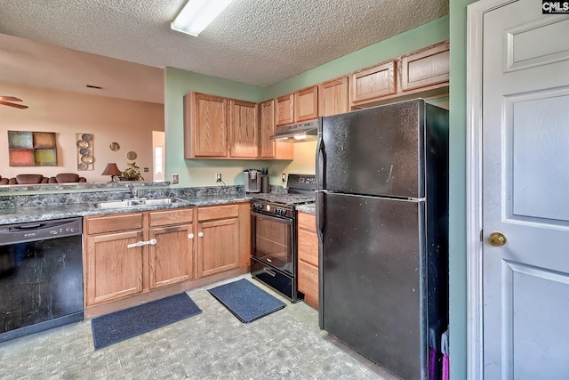 kitchen with a textured ceiling, sink, and black appliances