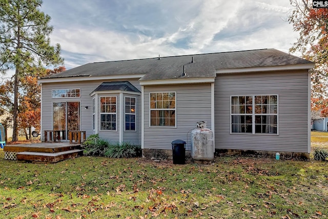 back of house with a lawn