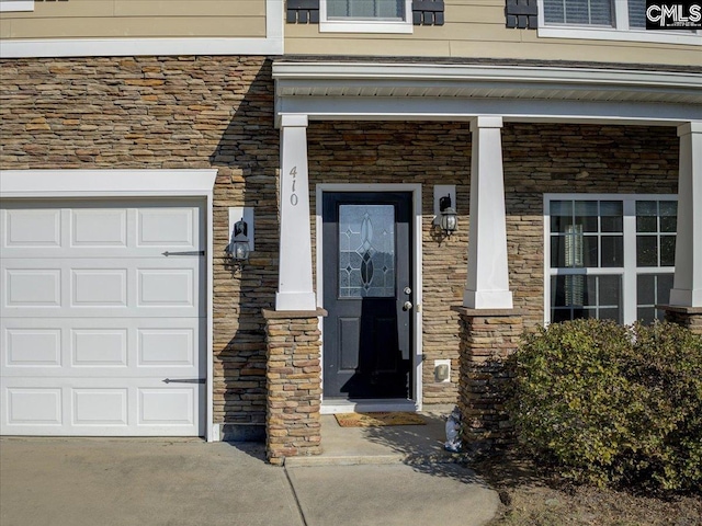 view of exterior entry featuring a garage