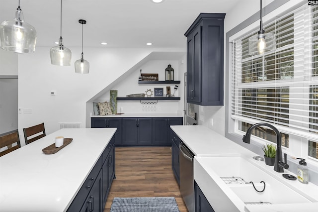 kitchen featuring dark wood-type flooring, dishwasher, sink, and pendant lighting