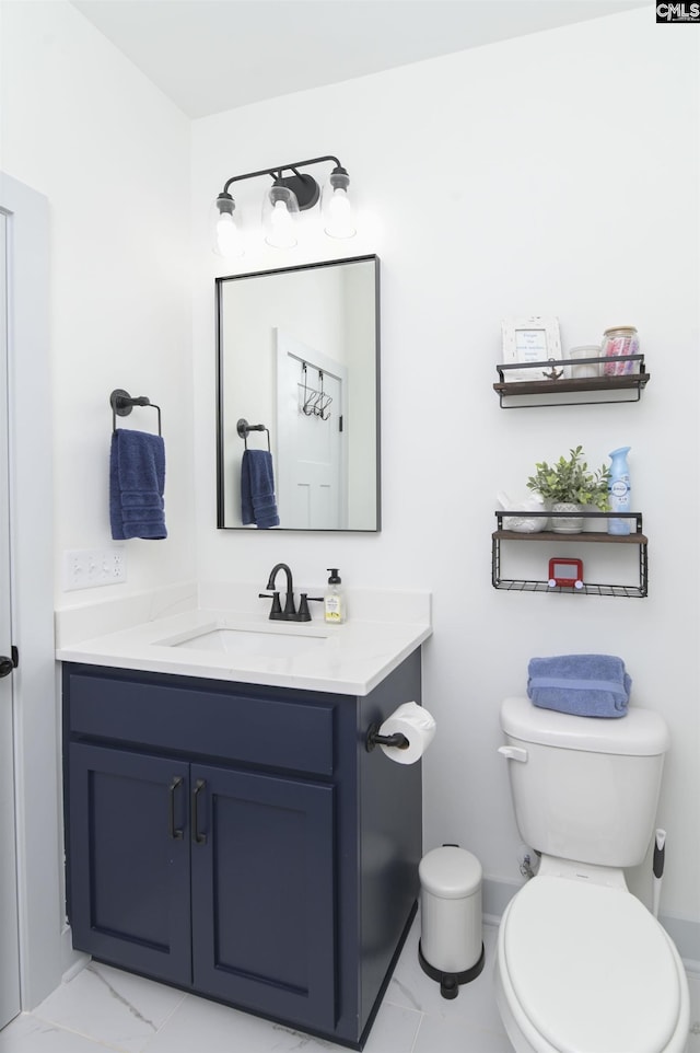 bathroom featuring vanity and toilet