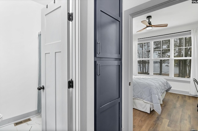 bedroom featuring multiple windows, ceiling fan, and dark wood-type flooring