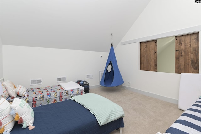 bedroom with light colored carpet and vaulted ceiling