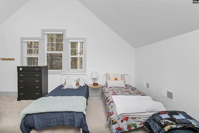 carpeted bedroom with high vaulted ceiling