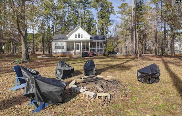 rear view of property with a sunroom