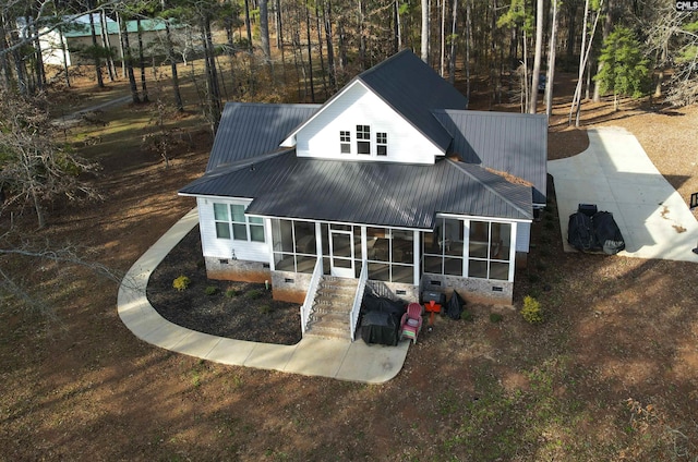 back of property with a sunroom