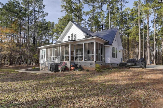 exterior space with a sunroom and central AC unit