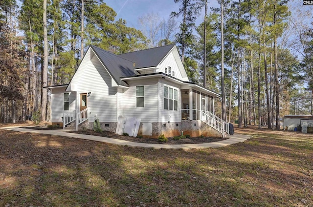 view of home's exterior featuring a sunroom