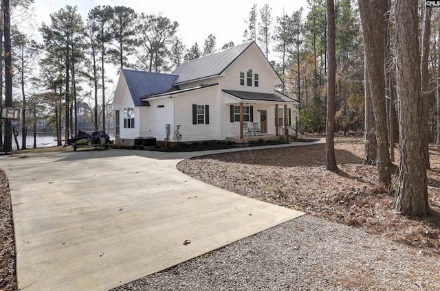 view of front of home featuring cooling unit and covered porch