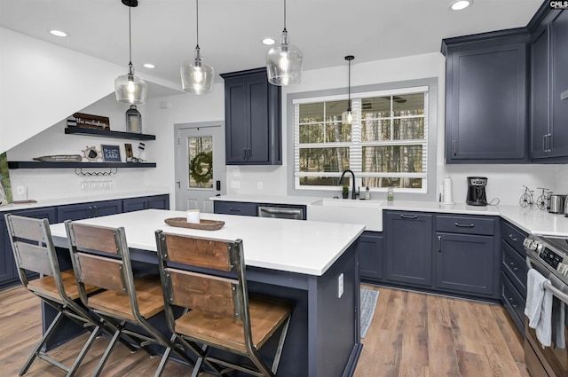 kitchen with pendant lighting, a kitchen island, dark hardwood / wood-style flooring, and stainless steel appliances