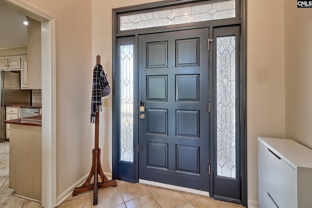 tiled foyer with a healthy amount of sunlight