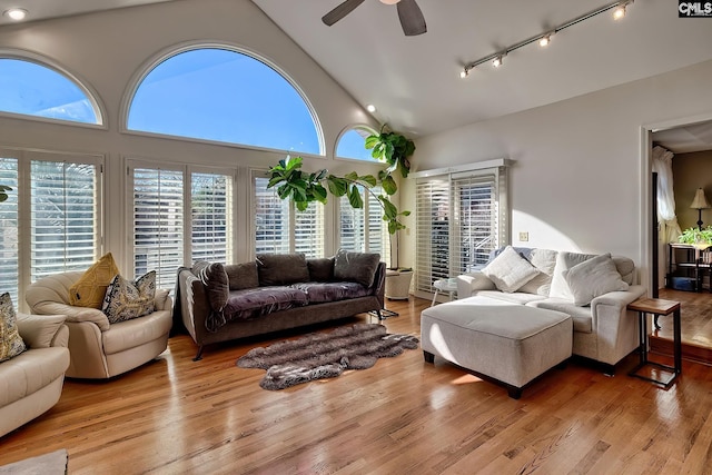 living room with ceiling fan, high vaulted ceiling, light hardwood / wood-style floors, and track lighting