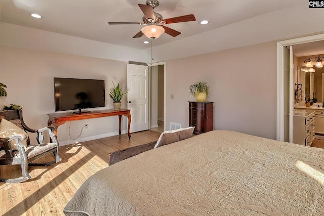 bedroom with ensuite bath, ceiling fan, and light wood-type flooring