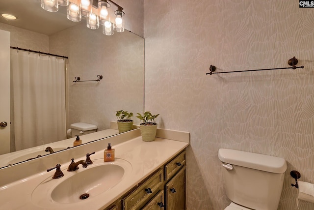 bathroom with vanity, a shower with shower curtain, and toilet