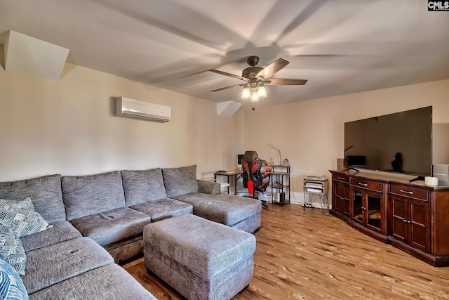 living room with ceiling fan, a wall mounted air conditioner, and light wood-type flooring