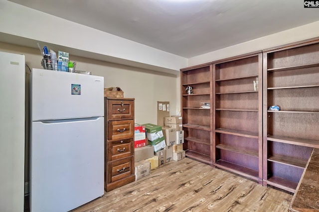 interior space with white fridge and light hardwood / wood-style floors