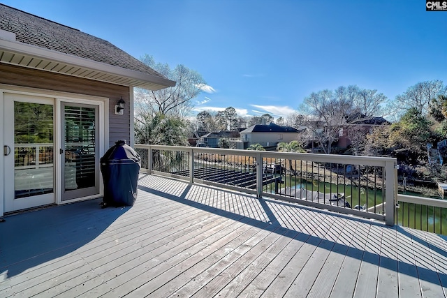 wooden deck featuring a water view