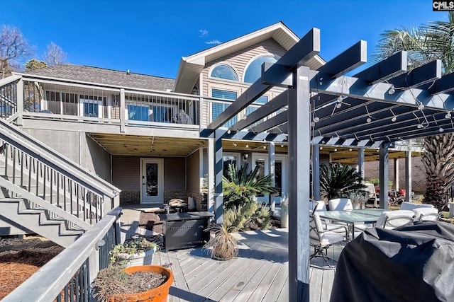 wooden deck featuring a pergola and a grill