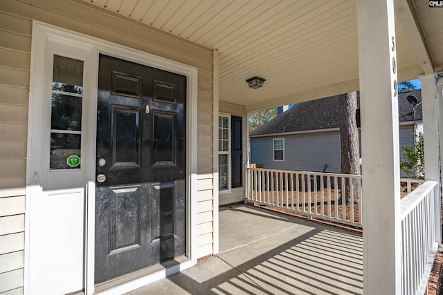 view of exterior entry featuring a porch