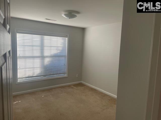 unfurnished room with light colored carpet