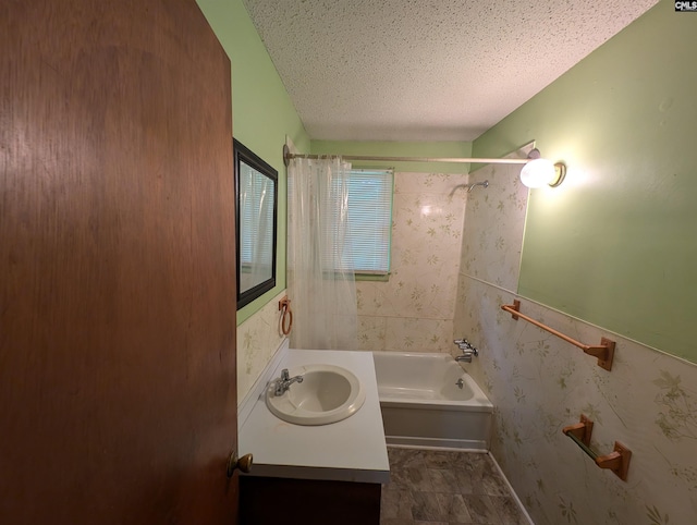 bathroom with vanity, a textured ceiling, and bathing tub / shower combination