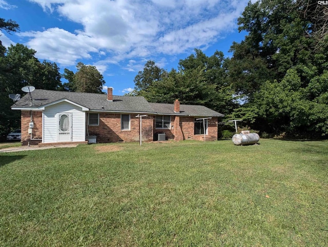 ranch-style home with a front yard and central AC