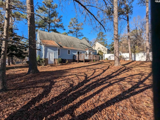 back of house with a wooden deck