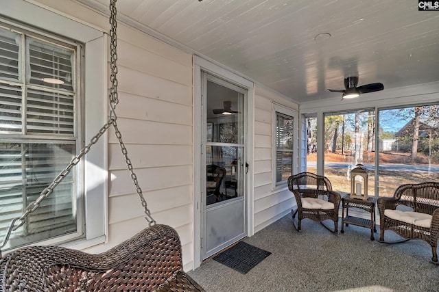 sunroom featuring ceiling fan