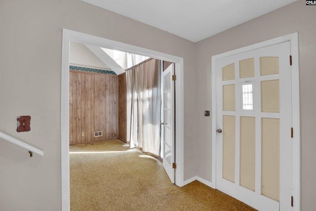 foyer entrance with plenty of natural light and carpet