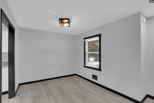 spare room with light hardwood / wood-style flooring