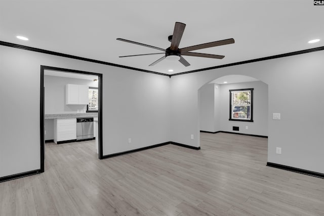 empty room featuring light hardwood / wood-style flooring, ceiling fan, and crown molding