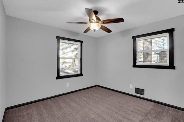 carpeted empty room with ceiling fan