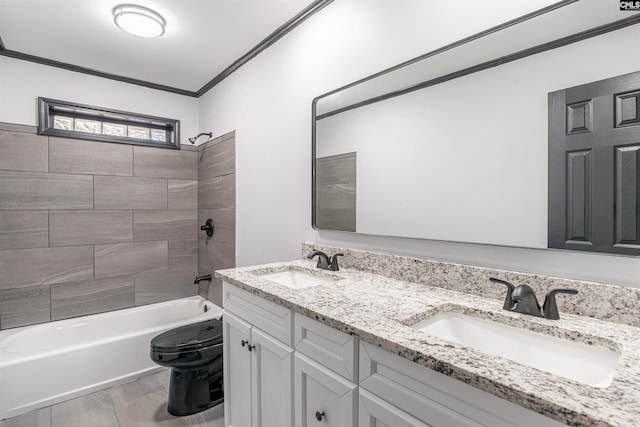 full bathroom with crown molding, vanity, tiled shower / bath combo, and toilet