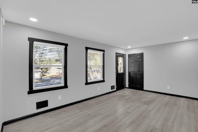 spare room featuring light hardwood / wood-style flooring