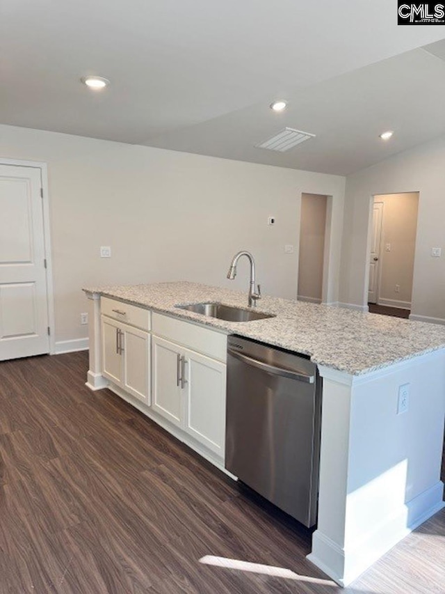 kitchen with light stone countertops, white cabinetry, dark hardwood / wood-style flooring, sink, and stainless steel dishwasher