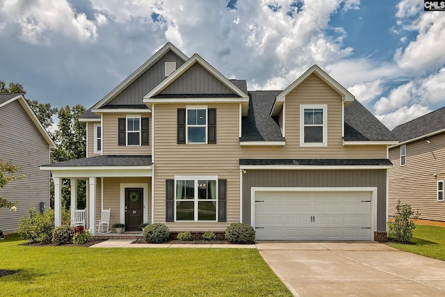 craftsman inspired home featuring a front yard and a garage