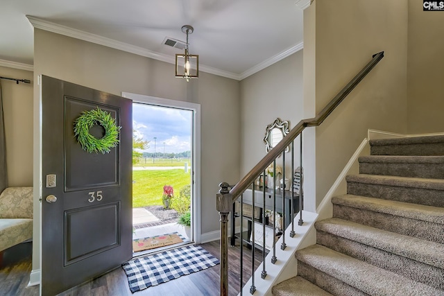 entrance foyer with hardwood / wood-style floors and ornamental molding