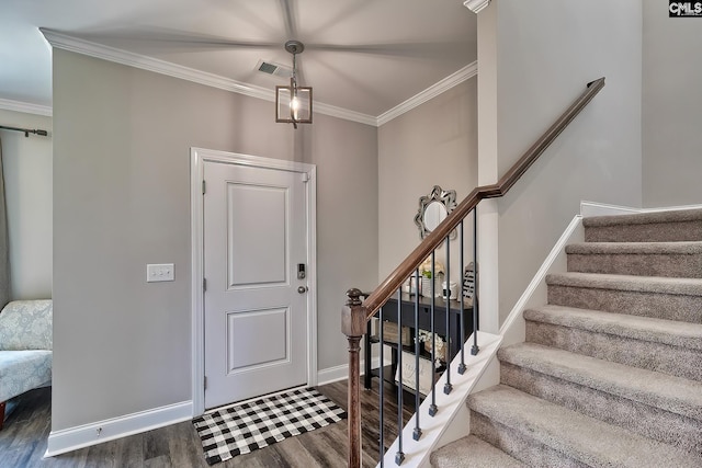 entrance foyer with dark hardwood / wood-style flooring and ornamental molding