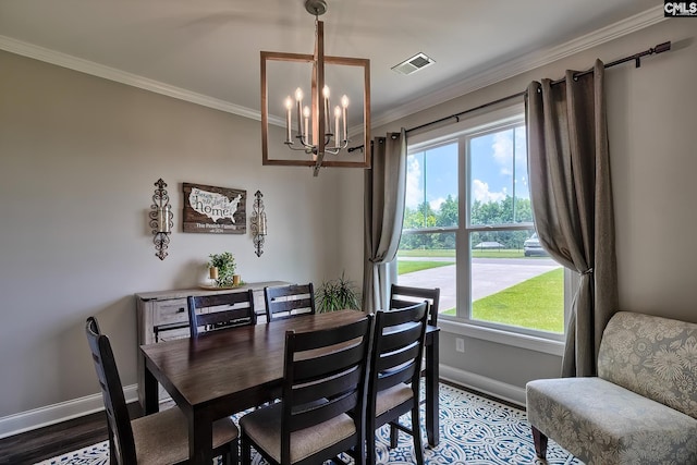 dining area with hardwood / wood-style floors, ornamental molding, and a notable chandelier